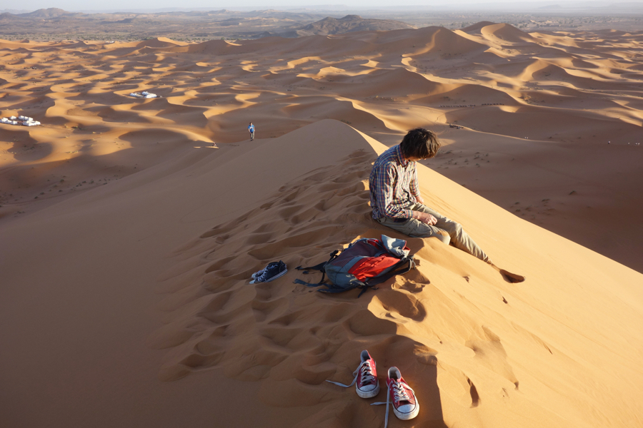 At the very top of the sand dune
