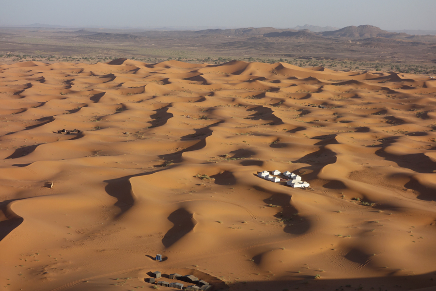 Tents. You can see how the dune turns into a stone desert.