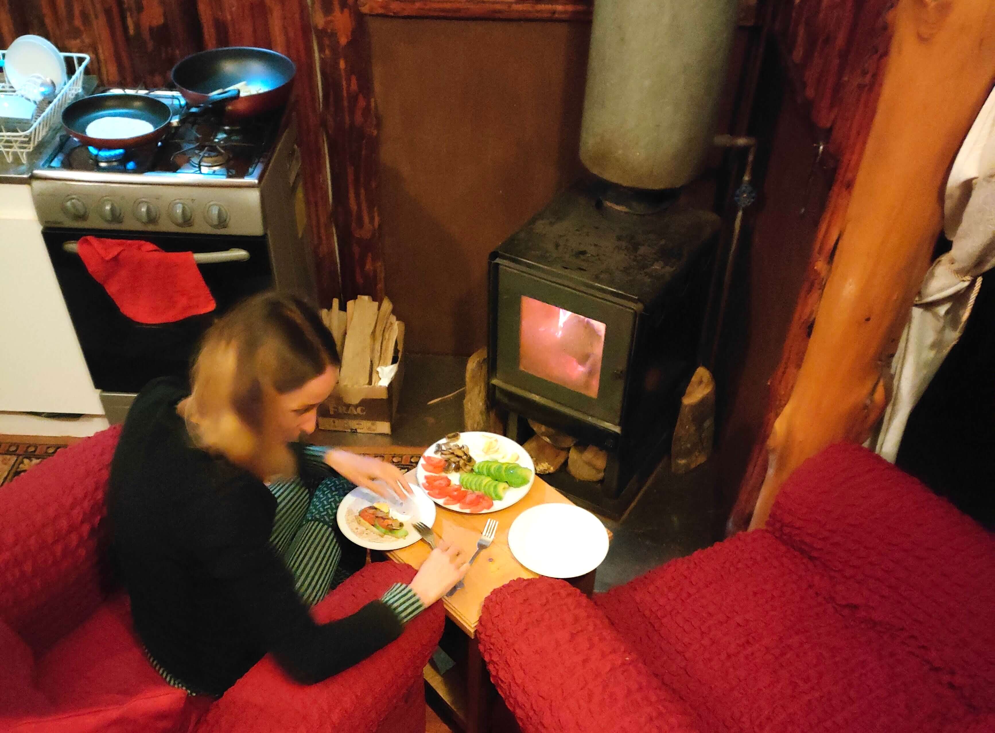 We’re having dinner by the little stove. Serzhyk rearranged things and brought two chairs here. It’s warm by the stove.