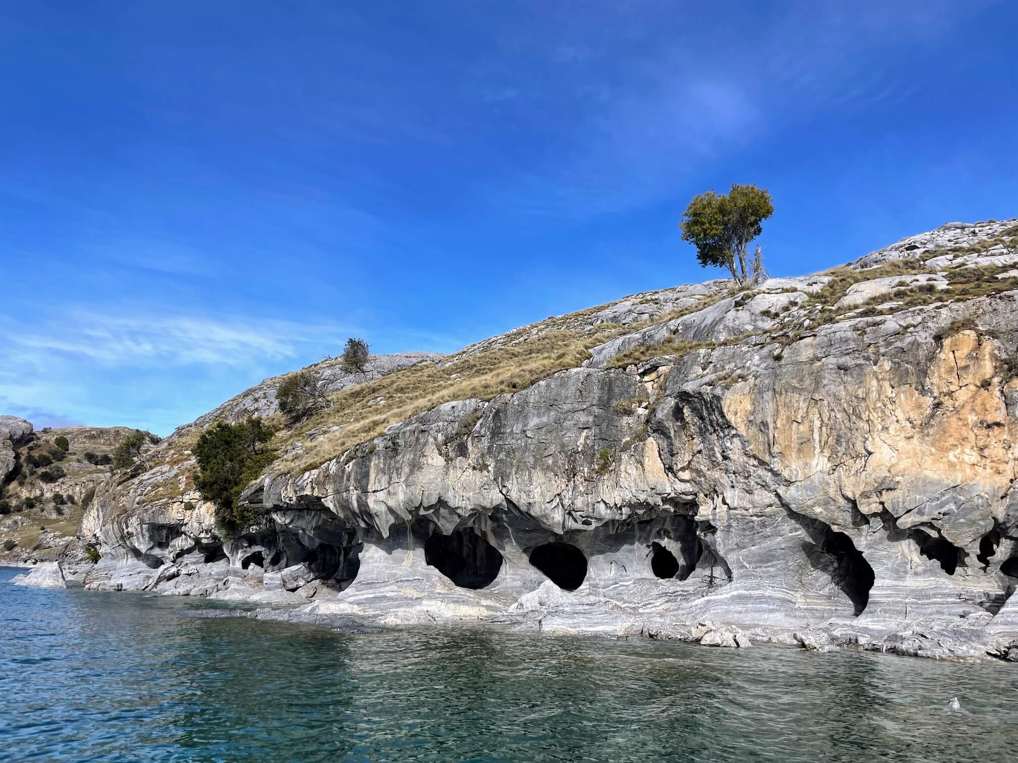 The shoreline of the lake. Water has washed away the marble for more than six thousand years. That is how these caves were formed.