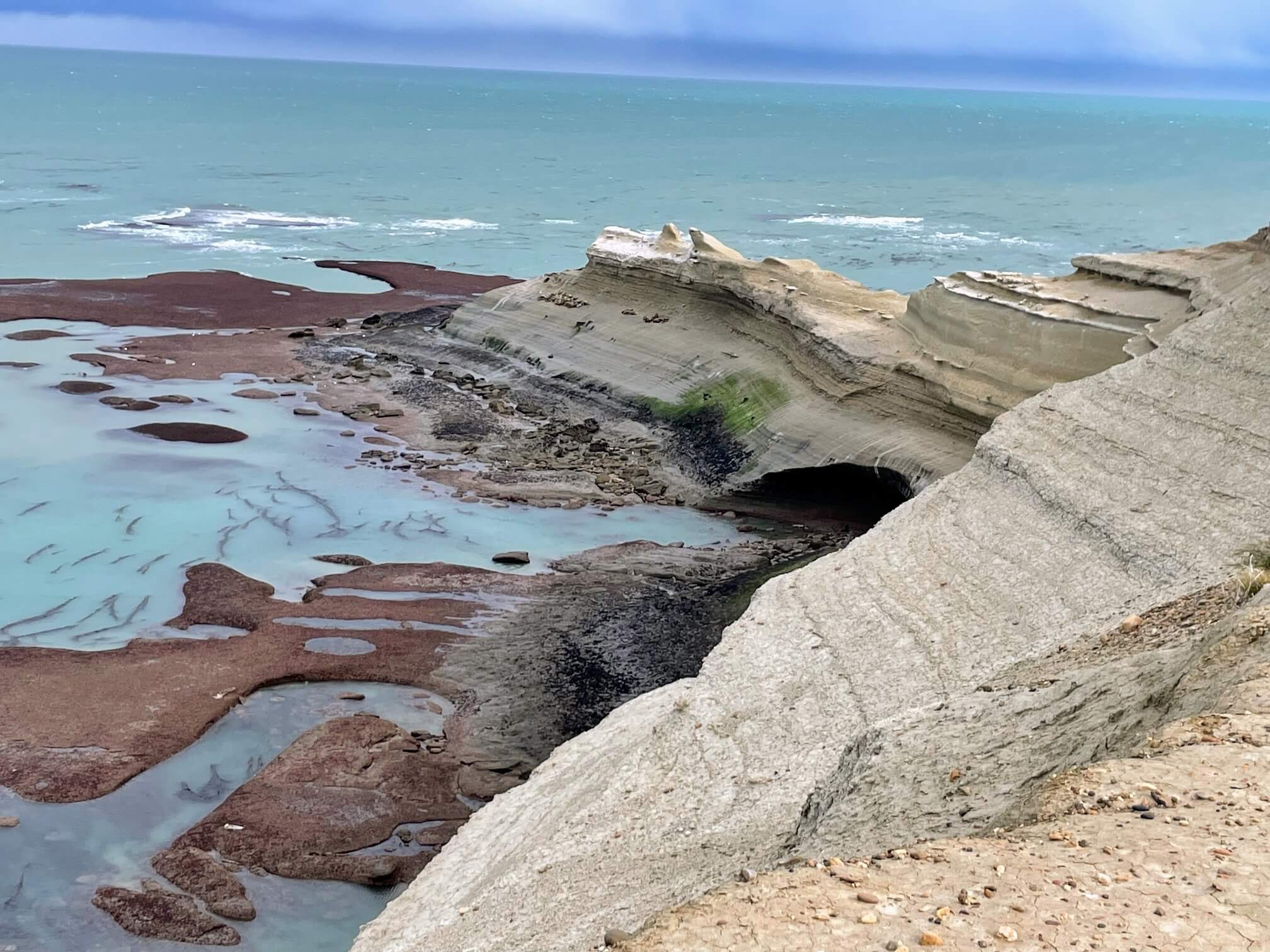 Lions on the rock. The water here is an incredible color.